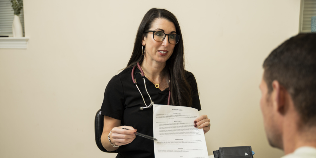 A woman discusses health concerns with a man in a doctor's office, emphasizing medication risks and side effects.